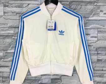 white adidas jacket with blue stripes