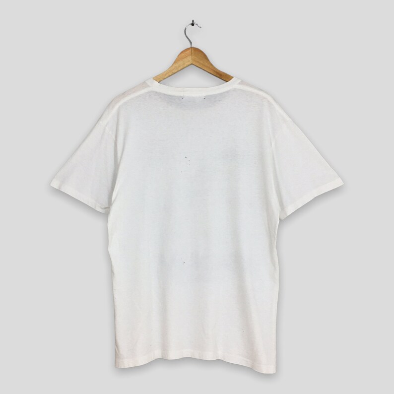 May include: White short-sleeved t-shirt with a crew neck.