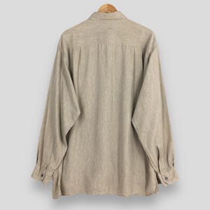 May include: A set of three ceramic mugs with a speckled, matte finish. The mugs are in shades of cream, light gray, and dark gray. Each mug has a simple, minimalist design and a rounded handle. Perfect for coffee or tea.