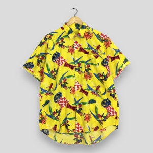 May include: A bright yellow short-sleeve button-down shirt featuring an all-over graphic print of cartoon characters on skateboards, red and white checkered flags, and red banners with the word BULLET printed in bold black letters.