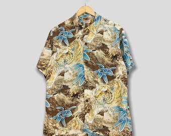 May include: A brown short-sleeved button-up shirt with a tiger and leaf pattern.