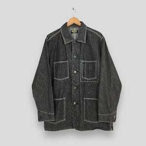 May include: A dark gray denim jacket with four front pockets and button closures. The jacket has a collared neckline and is hanging on a wooden hanger. The stitching is white, and the jacket has the text "One King" on the label.