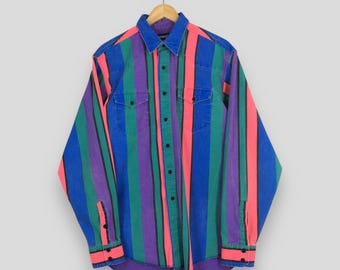 May include: A colorful, long-sleeved shirt with vertical stripes in blue, pink, green, and purple. The shirt has two chest pockets, black buttons, and buttoned cuffs. The collar and cuffs are a solid blue color.
