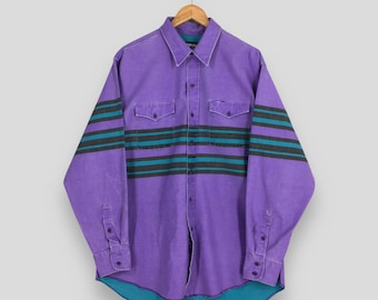 May include: A purple button-down shirt with long sleeves and a collared neckline. The shirt features two chest pockets and horizontal stripes in teal and gray across the sleeves and chest. The bottom hem and inner collar are teal.