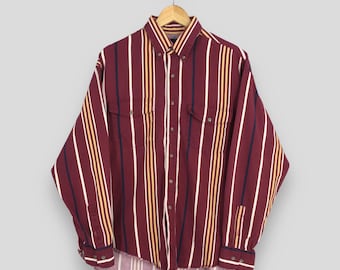 May include: A long-sleeved button-down shirt with vertical stripes in shades of burgundy, white, yellow, and navy blue.