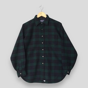 May include: A long-sleeved button-down shirt featuring a dark green and black plaid pattern. The shirt has a standard collar, a single chest pocket on the left side, and buttoned cuffs. It is displayed on a wooden hanger against a neutral background.