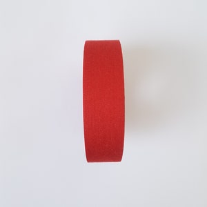 May include: A roll of red athletic tape.