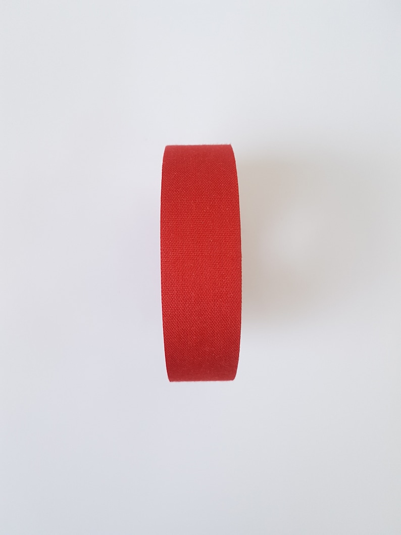May include: A roll of red athletic tape.