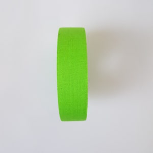 May include: A roll of bright green athletic tape.