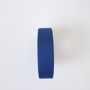 May include: A roll of blue athletic tape.