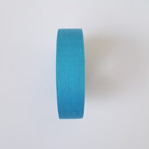 May include: A roll of blue fabric tape.