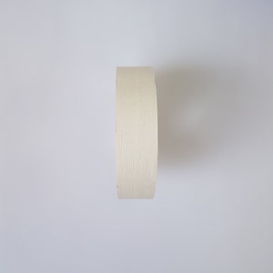 May include: A roll of white athletic tape, often used for sports injuries.