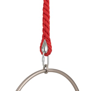 May include: A red aerial rope with a silver metal carabiner and a silver metal aerial hoop. The thick rope is attached to the carabiner, which is connected to the hoop. The background is white.