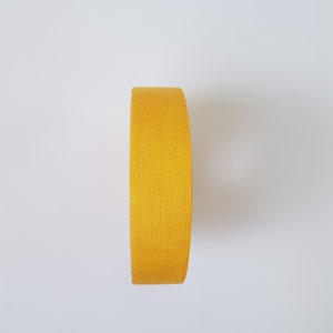 May include: A roll of yellow athletic tape.