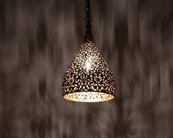 May include: A black metal pendant light with a decorative, intricate, cut-out design. The light is hanging from a chain and is illuminated.