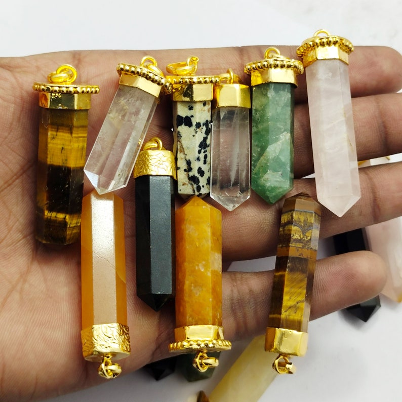 May include: Assortment of 10 gold-capped crystal point pendants. The pendants are made of various types of crystals, including clear quartz, tiger's eye, rose quartz, and black obsidian. Each pendant has a gold-plated bail for easy attachment to a necklace or bracelet.