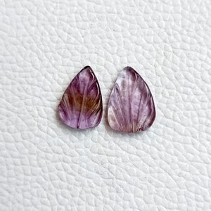 May include: Two carved amethyst gemstone pendants in a teardrop shape with a purple and brown colour gradient.