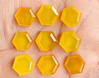 May include: Nine yellow hexagonal gemstones, each with a smooth, polished surface, arranged in a grid pattern.