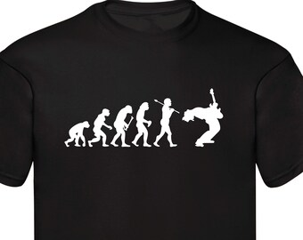 May include: A black t-shirt featuring a white graphic of the evolution of man, culminating in a person playing an electric guitar.