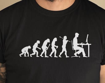 May include: A black t-shirt with a white graphic of the evolution of humans ending with a person sitting at a computer. The person is wearing a headset and looking at a computer screen.