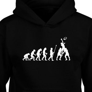 May include: Black hooded sweatshirt featuring a white silhouette of the evolution of man, culminating in a man catching a rugby ball.