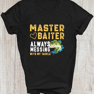 May include: Black t-shirt with the text "MASTER BAITER ALWAYS MESSING WITH MY TACKLE" in yellow and white. A green and white fish graphic is included. The shirt is made of a soft material.