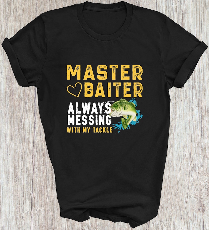 May include: Black t-shirt with the text "MASTER BAITER ALWAYS MESSING WITH MY TACKLE" in yellow and white. A green and white fish graphic is included. The shirt is made of a soft material.