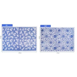 May include: Two blue and white ceramic tiles with floral patterns. The tile labeled "01" has a smaller, more intricate pattern. The tile labeled "02" has a larger, more bold pattern. Both tiles measure 47 cm by 35 cm.
