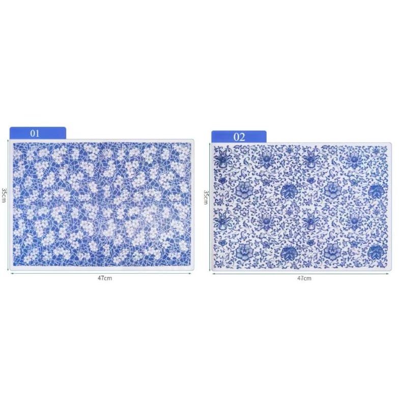 May include: Two blue and white ceramic tiles with floral patterns. The tile labeled "01" has a smaller, more intricate pattern. The tile labeled "02" has a larger, more bold pattern. Both tiles measure 47 cm by 35 cm.