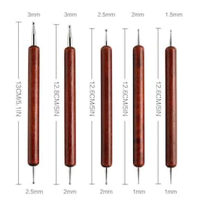 May include: Set of six double-ended dotting tools. Each tool has a wooden handle and a metal tip. The tools range in size from 1.5mm to 3mm, and are approximately 5 inches (12.6 cm) long.