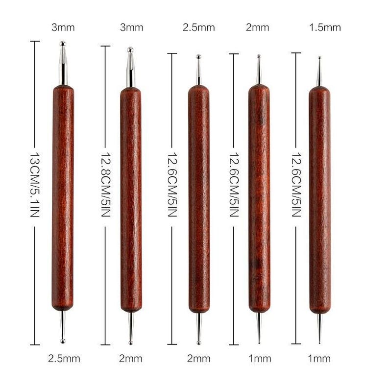 May include: Set of six double-ended dotting tools. Each tool has a wooden handle and a metal tip. The tools range in size from 1.5mm to 3mm, and are approximately 5 inches (12.6 cm) long.