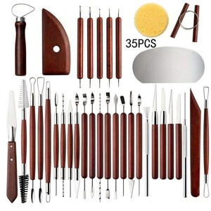 May include: A set of 35 pottery and sculpting tools. The tools include various shapes and sizes, with wooden handles and metal tips. A sponge, wire tool, and a curved wooden tool are also included. The text "35PCS" is visible.