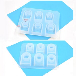 May include: A clear silicone mold with six ring-shaped cavities. The mold is 12 mm wide and 2.5 mm tall. The cavities are arranged in two rows of three.