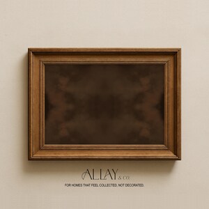 May include: A rectangular wooden picture frame with a dark brown finish and a multi-layered stepped edge design. The center is a dark, solid brown color. Below the frame, the text reads ALLAY & CO. FOR HOMES THAT FEEL COLLECTED, NOT DECORATED.