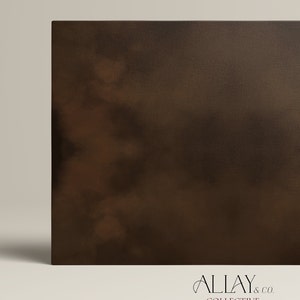 May include: A rectangular canvas print featuring a dark brown, mottled, and cloudy abstract pattern with a textured surface. The bottom right corner displays the text ALLAY & CO. COLLECTIVE in a thin, black, serif font against a light background.