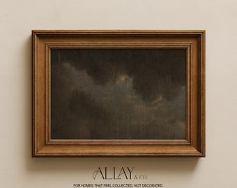 May include: A rectangular landscape painting in a dark brown wooden frame. The artwork depicts a moody, overcast sky with dark gray and black clouds and vertical streaks suggesting rain. Below the frame, the text reads ALLAY & CO. FOR HOMES THAT FEEL COLLECTED, NOT DECORATED.