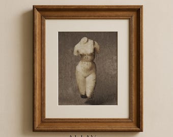 May include: A framed wall art print featuring a beige, headless, armless torso sculpture against a dark, textured background. The artwork is encased in a medium-brown wooden frame with a cream-colored mat. Text at the bottom reads ALLAY & CO.
