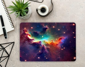 May include: A rectangular mouse pad featuring a vibrant space nebula design with swirling clouds of purple, blue, orange, and yellow gas, punctuated by numerous bright white stars and distant glowing points of light across a dark cosmic background.