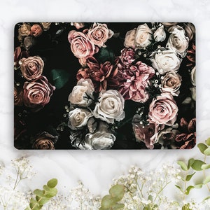 May include: A dark background with a floral pattern of pink, white, and red roses. The roses are arranged in a cluster and have a vintage aesthetic.