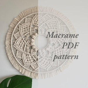 May include: A circular macrame wall hanging with a detailed geometric design. The piece is split into two halves, one in a natural beige and the other in white. The text "Macrame PDF pattern" is overlaid on the right side.