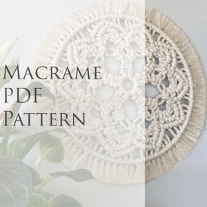 May include: A white macrame wall hanging with a circular design and fringe. The text "MACRAME PDF PATTERN" is visible in the image.