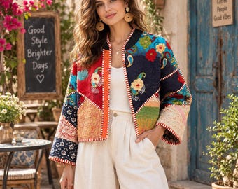 May include: A cropped jacket featuring a patchwork design with various floral and paisley patterns in red, blue, green, and yellow. The jacket has long sleeves, a round neckline, and a white and red striped trim along the front opening and cuffs.