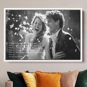 May include: Black and white photo of a couple smiling and laughing. The photo is framed in a white frame and has a handwritten message about love and marriage.