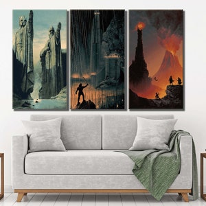 Op de afbeelding: Een driedelige wandkunstset met fantasy-illustraties. Het linkerpaneel toont twee grote stenen beelden bij een rivier. Het middelste paneel toont een donker fort in de regen met een figuur die een staf vasthoudt. Het rechterpaneel toont een vulkaanlandschap.