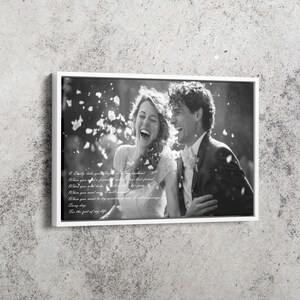 May include: A black and white framed canvas print featuring a laughing couple amidst falling petals. The text reads: I, Emily, take you Stefan, to be my husband. When you need a friend, I will be your best friend. When you need help, I will be there for you.