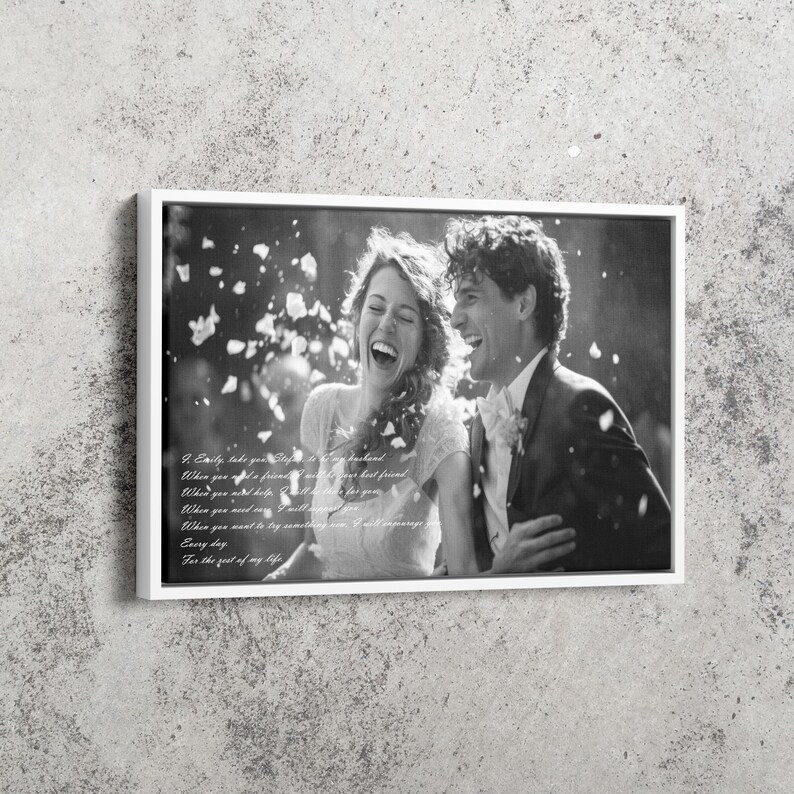 May include: A black and white framed canvas print featuring a laughing couple amidst falling petals. The text reads: I, Emily, take you Stefan, to be my husband. When you need a friend, I will be your best friend. When you need help, I will be there for you.