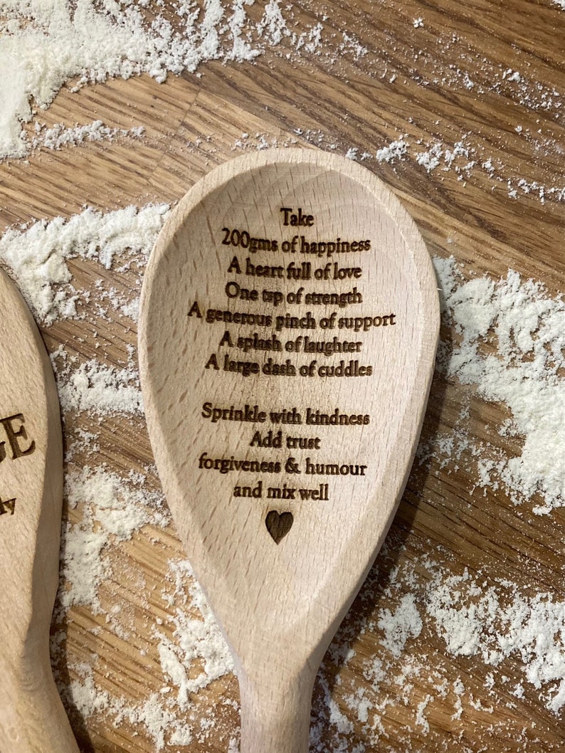 Wooden  spoon with a recipe for happiness engraved on it. The recipe includes 200 grams of happiness, a heart full of love, one teaspoon of strength, a generous pinch of support, a splash of laughter, a large dash of cuddles, a sprinkle of kindness, trust, forgiveness and humour, and to mix well.