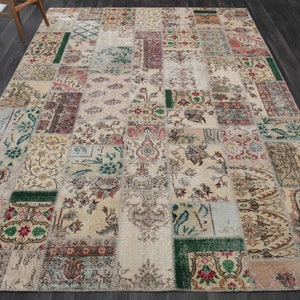 Könnte beinhalten: Ein Patchwork-Teppich mit cremefarbenem Hintergrund und bunten Blumenmustern. Der Teppich besteht aus verschiedenen Stoffstücken, die zusammengenäht wurden und so einen einzigartigen und vielseitigen Look erzeugen.