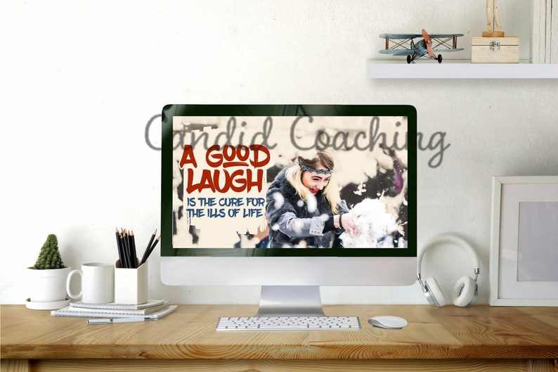 May include: A computer screen displaying a quote about laughter. The quote reads "A good laugh is the cure for the ills of life." The background of the quote is a snowy scene with a woman playing in the snow.