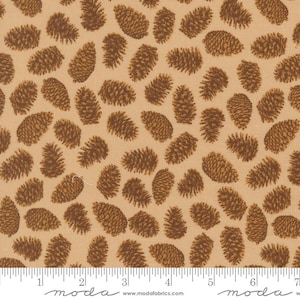 May include: Tan fabric with a repeating pattern of brown pine cones. The pine cones are detailed with textured shading, creating a realistic appearance. The fabric has a ruler printed along the bottom edge.